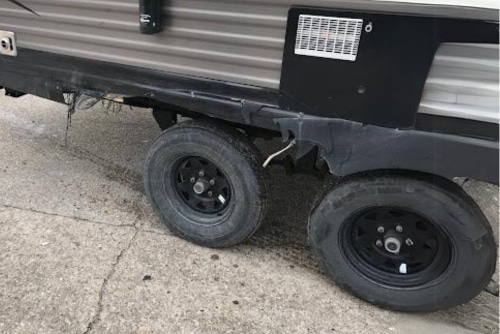 Expert RV trailer blowout damage repair in LaPlace, LA with RV Masters. Image of damage caused by a tire blowout on an RV in for repairs.