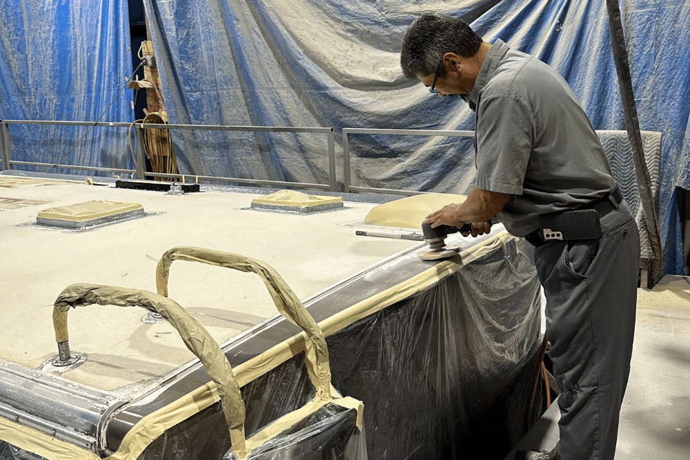 RV roof repair by RV Masters in LaPlace, LA: A technician working diligently on an RV roof repair in a facility, showcasing the attention to detail and expertise that goes into maintaining and repairing RV roofs to ensure long-term durability and protection against the elements.