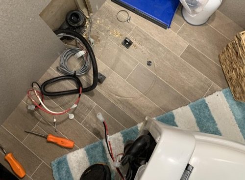 Plumbing repairs in action. A macerating toilet in an RV is repaired after a clorox wipe was flushed and became stuck in the macerator.